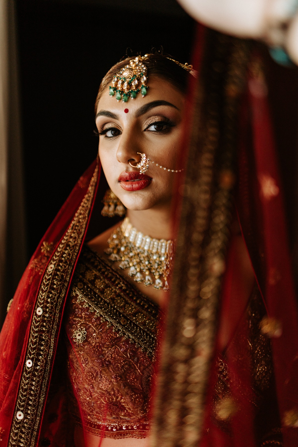 Indian bride in red and gold sari