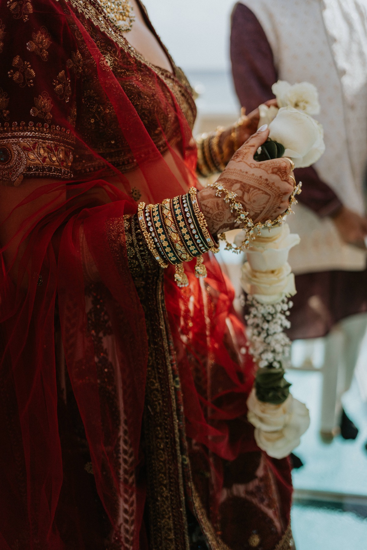 bride with henna wearing a red sari during a Hindu wedding ceremony